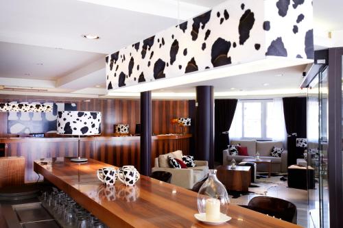 a restaurant with a bar with a table and chairs at Hotel MU in La Cortinada