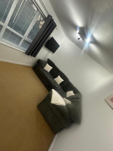 a living room with a couch and a window at A Home From Home in Crawley