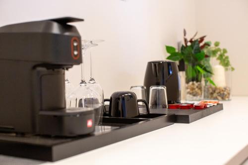 a kitchen counter with a coffee machine on it at Corso Grand suites in Barletta