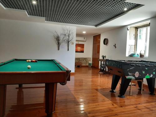 a living room with a pool table at casa na aldeia - entre Fundão e Covilhã in Pêro Viseu
