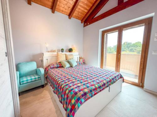 a bedroom with a bed and a blue chair at un MONDO A PARTE in Monsampolo del Tronto