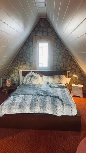a bedroom with a large bed in a attic at Ski Alm - Ferienunterkunft in Zella-Mehlis