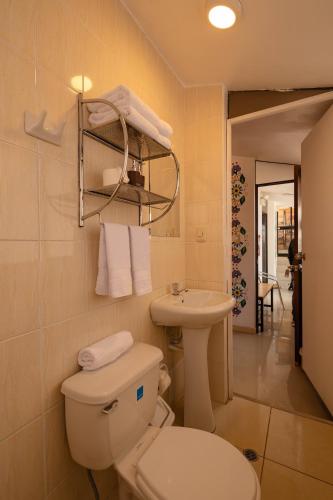a bathroom with a toilet and a sink at Mayu Boutique Hotel in Cusco
