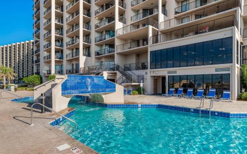 a swimming pool in front of a building at Phoenix East 002 in Orange Beach