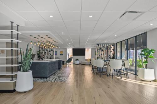 an office lobby with white chairs and a table at B&B HOTEL Orlando International Drive near Universal - Newly Renovated! in Orlando