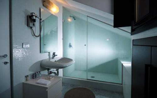 a bathroom with a sink and a glass shower at Nine Hotel in Monza
