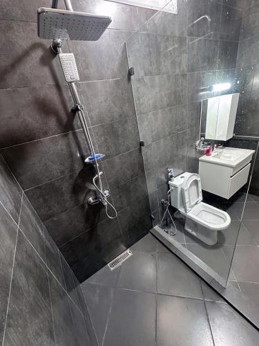 a bathroom with a shower with a toilet in it at Relaxing Apartment Near the Beach Malabata Tanger in Tangier