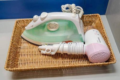 a wicker basket with a hair dryer and a hair brush at The Ring Residence in Sathani Hat Yai