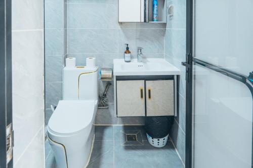 a bathroom with a white toilet and a sink at Kilimani Chic Studio in Nairobi
