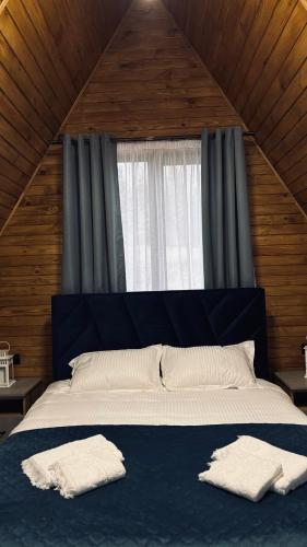 a bedroom with a large bed with two towels on it at Torino Resort & Spa in Dragonya