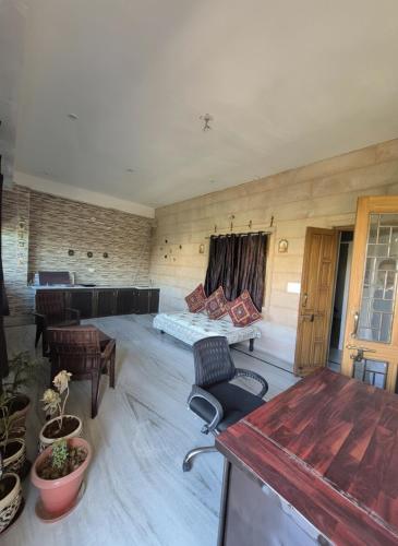 a living room with a bed and a table at Kripanidhi Homestay in Jodhpur