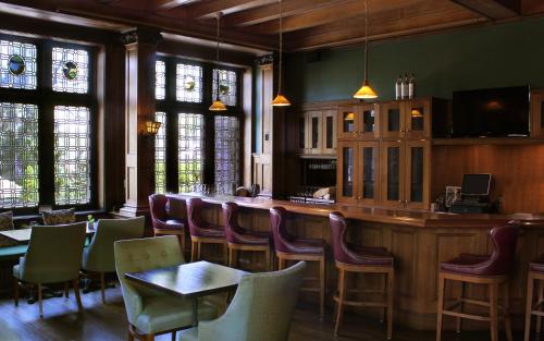 a bar in a restaurant with tables and chairs at Mansions on Fifth in Pittsburgh