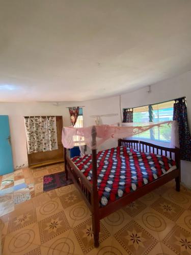 a bedroom with a bed in a room at SALEM Eco-Lodge & Guesthouse in Mbale