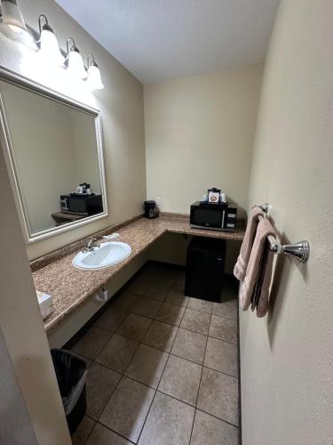 a bathroom with a sink and a mirror at The Rushford Inn in Rushford