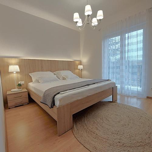 a bedroom with a large bed and a large window at Villa Bacio with heated pool, starlink internet in Brštanovo