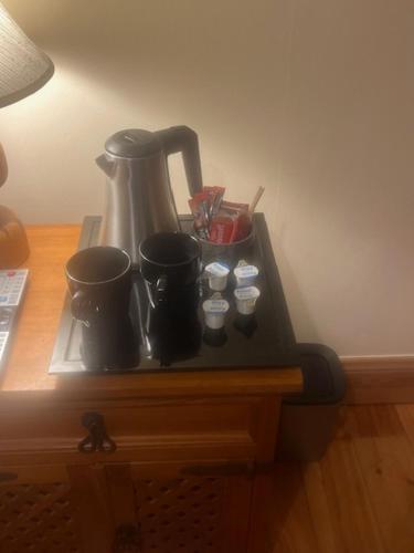 a counter with a coffee maker and cups on it at Ríocht Fódla 2 in Killarney