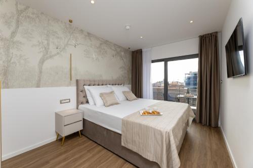 a bedroom with a large bed and a large window at Sunday Residence Split in Split