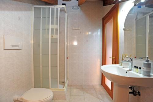 a bathroom with a shower and a toilet and a sink at Urban Oasis in Cormano