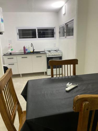 a kitchen with a table with a black table cloth on it at Quintas Baradero in Baradero