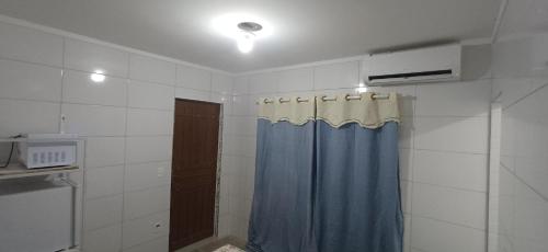 un bagno con doccia e tenda da doccia blu di Taberna dos Castilho 1 a Bertioga
