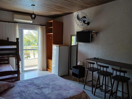 En eller flere senge i et værelse på Pousada Recanto Solarium