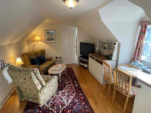 a living room with a couch and a table at Walkers Retreat with garden and views in Holne
