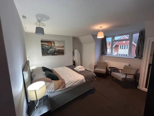 a bedroom with a bed and a chair in it at The Nook in Bedford
