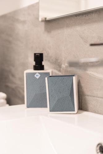 a bottle of perfume sitting on top of a counter at B&B Maison Sophie SOVERATO MARINA in Soverato Marina