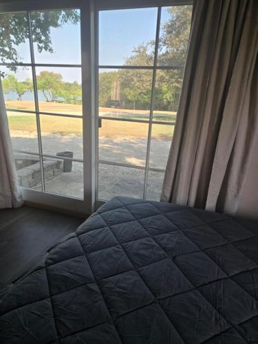 een slaapkamer met een bed voor een raam bij Shahan Oasis in Little Elm