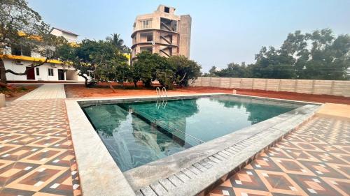 une piscine devant un bâtiment dans l'établissement La Nature Retreat, à Kuilapayam