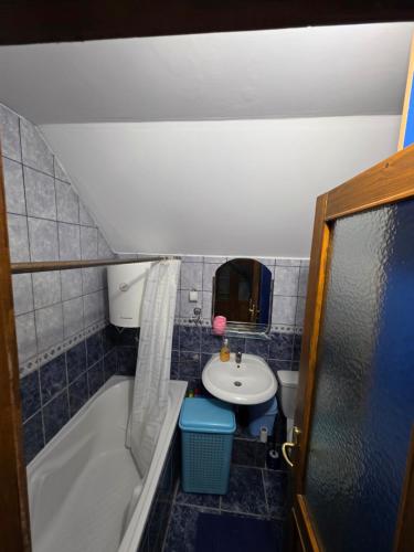 a small bathroom with a sink and a bath tub at D&D Apartment in Koceljevo