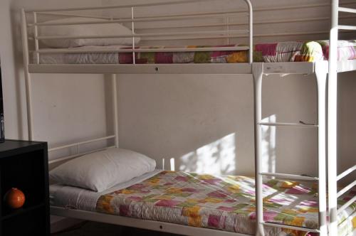 a bunk bed in a room with a bunk bed gmaxwell gmaxwell gmaxwell gmaxwellythonython at Viale Repubblica 307 4 in Pietra Ligure