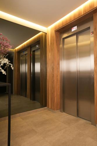 a row of elevator doors in a building at Aira Apart Hotel Boutique in Buenos Aires
