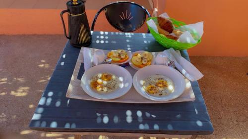 a blue table with two plates of food on it at Hôtel Blak and White de Toubab Dialao in Rufisque