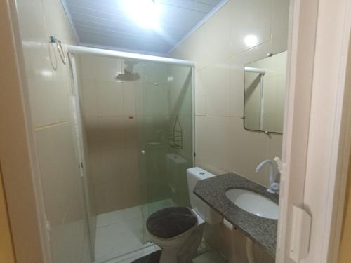 a bathroom with a shower and a toilet and a sink at kit Net B in São Luís