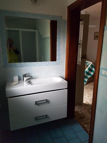 a bathroom with a sink and a mirror at Appartamento Cervia in Cervia
