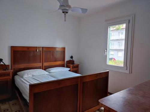 a bedroom with a bed and a window at Appartamento Cervia in Cervia