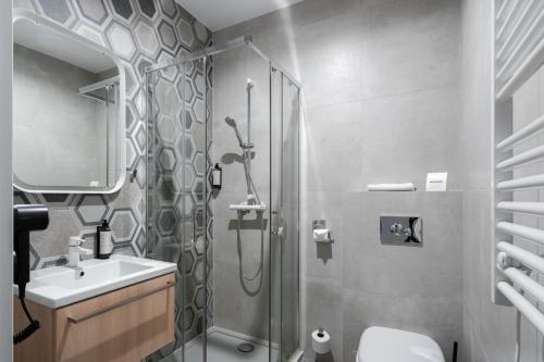 een badkamer met een douche en een wastafel bij Aquapark Reda Resort - jedyne noclegi w Aquaparku Reda in Reda