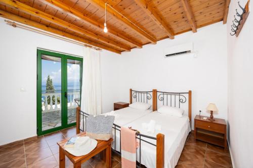 a bedroom in a villa with a bed and a table at Villa Anastasia in Ieromónachos