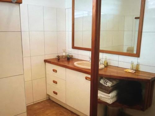 a bathroom with a sink and a mirror at Amazing view in Port Vila