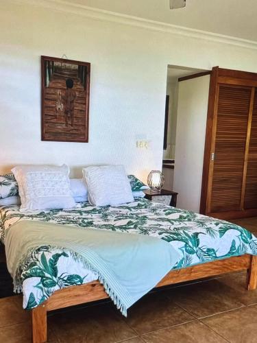 a bedroom with a bed with blue and white pillows at Amazing view in Port Vila