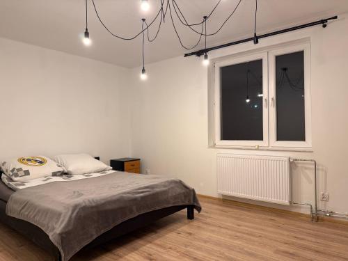 a white room with a bed and a window at Silesia młyn in Katowice