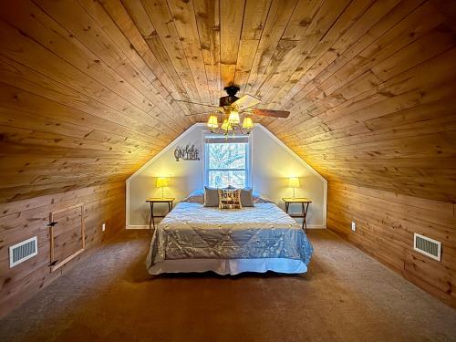 a large bedroom with a bed in a wooden ceiling at Lake Front Sunset | New Deck | Kayaks | Canoe in Salisbury