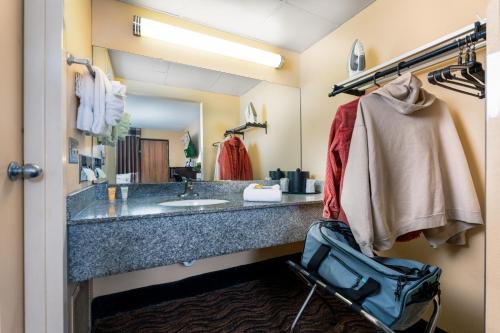 a bathroom with a large counter with a sink at MCM Grande FunDome Odessa in Odessa