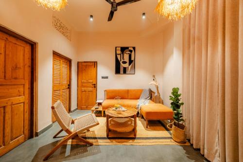 a living room with a couch and a table at ONEOFF X ASSI - A Boutique Homeotel in Varanasi