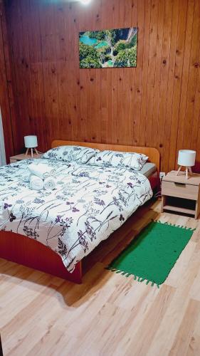 a bedroom with a bed and a wooden wall at Apartments with balcony and with large free parking House Oliver in Plitvička Jezera
