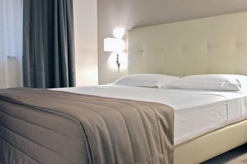 Postel nebo postele na pokoji v ubytování Hotel Desiderio