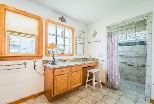 a bathroom with a shower and a sink at This is it - Nags Head MP 16, Ocean View, 75 Yards to Beach, Elevator, Wheelchair Friendly, Flex Stays in Nags Head