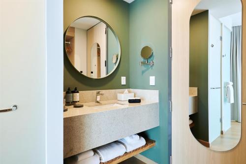 a bathroom with a sink and a mirror at WorldHotels Guadalajara Zona Andares in Guadalajara