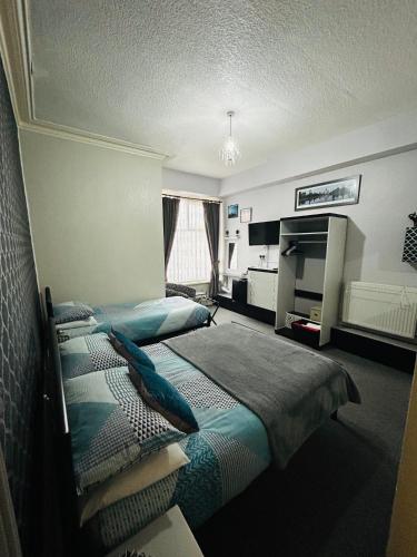 a hotel room with two beds and a fireplace at Hornby Villa B&B Couples & Families Only- Quiet Central Location- Near To Winter Gardens in Blackpool
